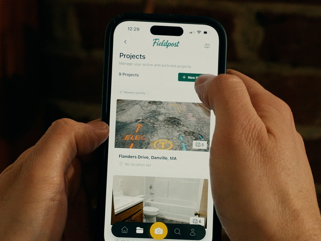 Fieldpost app on a jobsite — tap to play the product demo